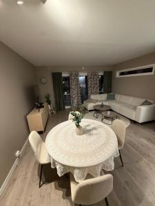a living room with a table and chairs and a couch at Apartment 3 minutes from cablecar in Tromsø