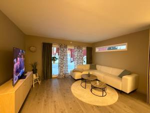 a living room with a couch and a table at Apartment 3 minutes from cablecar in Tromsø