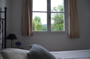 a bedroom with a bed and a large window at Chateau de Salorges - Field gite I in Corancy +60 photos