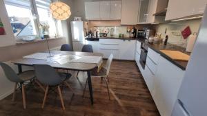 a kitchen with a table and chairs in it at Moderne Wohnung Cathy in Bad Iburg