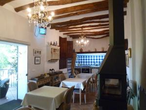 a kitchen with tables and a stove in a room at Casa Rural El Gaiter in Aguaviva