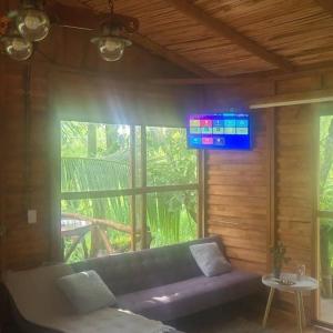 a living room with a couch and a tv at Tree House River in Palma