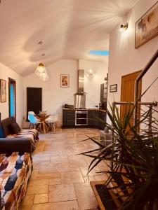 a living room with a couch and a table at Woodland, Canal & Lakeside Cottage in Ellesmere