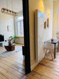 a living room with a table and a dining room at Appartement Premium à Liège in Liège +33 photos