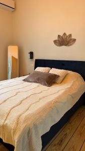 a bedroom with a large bed with a large flower on the wall at Appartement Premium à Liège in Liège