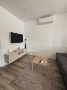 a living room with a couch and a coffee table at ROYAL homes in Nesvady