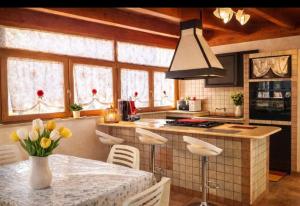 a kitchen with a table with a vase of flowers at VILLA DEI CICAS in Taranto
