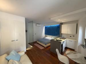 a kitchen and a living room with a bed and a couch at Mare Mosso 1 in Manarola