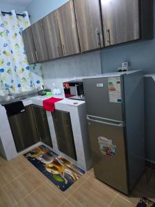 a kitchen with a sink and a refrigerator in it at Tulivu 2 stays in Nyahururu +1 photo