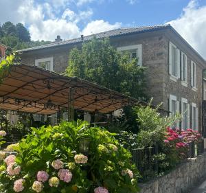 a garden with flowers in front of a building at Hotel U Campanile in Vivario