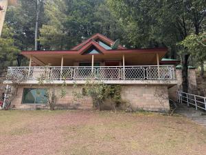 a house with a balcony on top of it at 2 bedroom Villa in Bhurban in Bhurban +10 photos