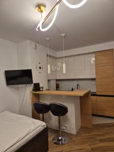 a bedroom with a bed and a kitchen with a counter at Apartament Golden Flight in Warsaw +25 photos