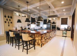 a large kitchen with a large wooden bar with black chairs at Pandora's Manor in High Point
