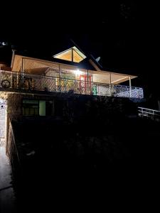 a house with a balcony with lights on it at night at 2 bedroom Villa in Bhurban in Bhurban