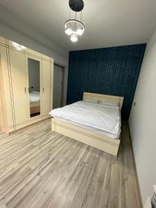 a bedroom with a bed and a blue wall at Ismayil Shikhseyidov in Küsnǝt +6 photos