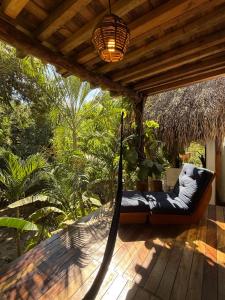 a porch with a hammock on a deck at La baxada in Mazunte