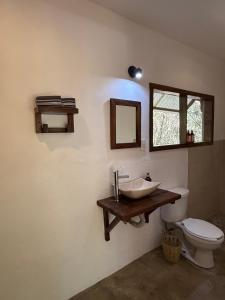 a bathroom with a sink and a toilet at La baxada in Mazunte