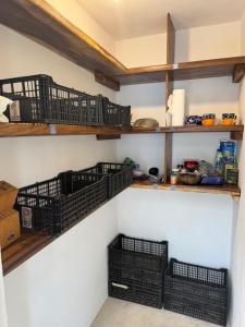 a room with shelves with baskets on the wall at La baxada in Mazunte