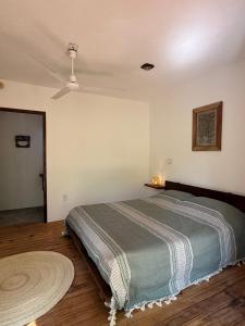 a bedroom with a bed in a room with a ceiling at La baxada in Mazunte