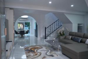 a living room with a couch and a table at GORGEOUS NEW DESIGNED 4br KataBeach sweetHome in Kata Beach