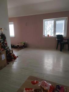 an empty living room with a christmas tree in a room at Vila Vera in Futog