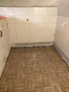 a room with a wooden floor and white tiled walls at Vila Vera in Futog