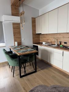 a kitchen with a table and chairs and a sink at Lunara Vlasic in Vlasic