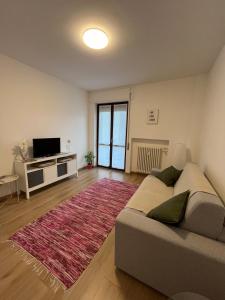 a living room with a couch and a rug at ALPI & RELAX Sondrio - zona Ospedale - centro città in Sondrio
