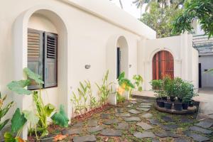 a house with a stone walkway in front of it at Kash Beach Villa, Varkala - Steps from Odayam Beach in Varkala