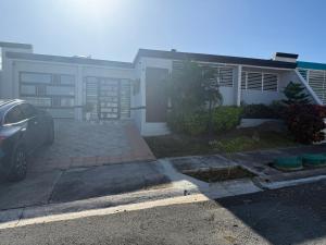 a house with a car parked in front of it at La Posadita in Carolina +8 photos