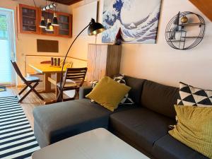 a living room with a couch and a table at White Rabbit Apartment in Spital am Semmering +20 photos