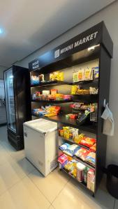a food section of a grocery store with a refrigerator at Flat Premium no Centro Tudo a Pé in Montes Claros