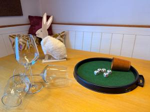 a table with wine glasses and a plate with balls on it at White Rabbit Apartment in Spital am Semmering