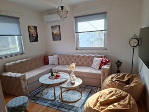 a living room with a couch and a table at Nature escape Sarajevo in Kasatići