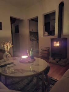 a living room with a table with a candle on it at Nature escape Sarajevo in Kasatići
