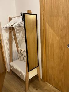 a mirror sitting next to a chair next to a closet at Senhora da Estrela AL in Seia