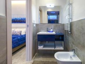 a bathroom with a sink and a bed at Delphi Soggiorni Romantic Suites with Private Terrace - Ischia Porto in Ischia Town +74 photos