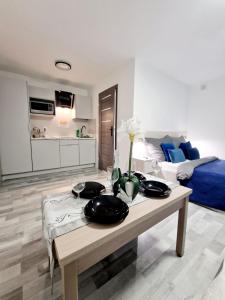 a living room with a table and a couch at Angel in Kołobrzeg