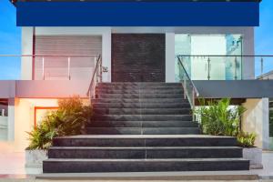 a set of stairs in front of a building at Super Townhouse Lohegaon Near Pune Airport Formerly Landmark Regency in Pune +45 photos