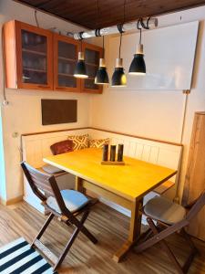 a dining room with a wooden table and chairs at White Rabbit Apartment in Spital am Semmering