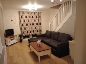 a living room with a couch and a coffee table at Noglas in Ammanford