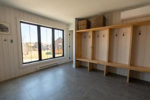 a large room with wooden cabinets and a window at Luna - 5 chambres - 14 personnes in Saint-Férréol-les-Neiges