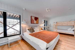 a bedroom with a bed and a large window at Luna - 5 chambres - 14 personnes in Saint-Férréol-les-Neiges +14 photos