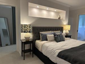 a bedroom with a large bed with two night stands at Solara Retreat Mildura in Mildura +59 photos
