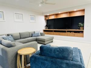 a living room with a couch and a tv at Solara Retreat Mildura in Mildura