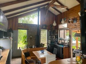 a kitchen with wooden walls and a large window at La Casona del Trancura in Pucón