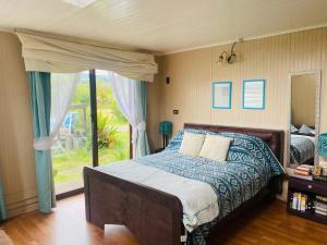 a bedroom with a bed and a large window at La Casona del Trancura in Pucón