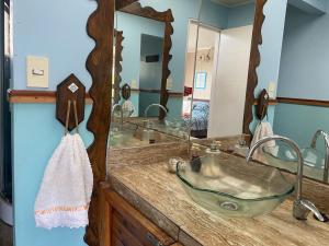 a bathroom with a sink and a large mirror at La Casona del Trancura in Pucón +49 photos