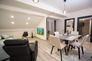 a dining room and living room with a table and chairs at Fort Vista in Knin +7 photos