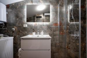 a bathroom with a sink and a shower at Fort Vista in Knin